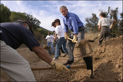 President Bush and Governor Jeb Bush, far right, talk with National Park Service Personnel during a visit to Everglades National Park June 4, 2001. .It will require the best efforts of all involved for a long period of time, from government officials to tribal leaders to landowners and environmentalists,. said the President about the restoration efforts. .The hard work, patience and goodwill of these groups have brought us thus far in restoring the Everglades. We will need the same qualities to finish the job in years ahead.