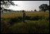 President Bush takes a walk among wild flowers at his Ranch in Crawford, Texas, May 23, 2003. The President and Mrs. Bush are replacing planted grass and landscaping by re-introducing the natural local fauna. .. . .we're right now cultivating 50 acres of little blue stem which was the original prairie grass that would have been there,. said Laura Bush of their efforts during the 2004 Spring White House Garden Tour preview.