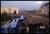 Standing with Romanian President Iliescu, President George W. Bush waves to thousands of Romanians in Revolution Square in Bucharest, Romania, Nov. 23, 2002. The square is the site of the 1989 revolt that toppled communist rule and where the Romanian people denounced the dictator Nicolae Ceausescu. 'And here, in December of 1989, you broke the silence of your captivity,' remarked President Bush. 'From that balcony, the dictator heard your voices and faltered -- and fled. Two generations of bitter tyranny ended, and all the world witnessed the courage of Romania, the courage that set you free.' White House photo by Paul Morse