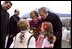 President George W. Bush and Laura Bush are greeted by children at the airport in Bucharest, Romania Saturday, Nov. 23, 2002. White House photo by Susan Sterner.