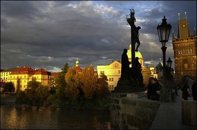 The sun sets on the St. Charles bridge in Prague.