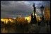 The sun sets on the St. Charles bridge in Prague.