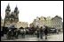 Shopkeepers gather in the morning at one of Prague's historic town squares.