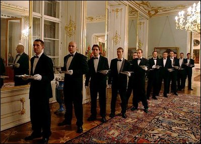 Waiters stand in line to serve attendees of a dinner hosted by the Czech Republic for NATO leaders at Prague Castle in Prague, Czech Republic on Nov. 20. 