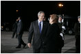 President George W. Bush and Latvia's President Vaira Vike-Freiberga pause for a moment at Riga International Airport after the President and Mrs. Bush arrived on the first stop of their four-day, four-country visit to Europe.