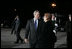 President George W. Bush and Latvia's President Vaira Vike-Freiberga pause for a moment at Riga International Airport after the President and Mrs. Bush arrived on the first stop of their four-day, four-country visit to Europe.