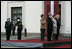 President George W. Bush and Laura Bush and Latvia President Vaira Vike-Freiberga and husband Imants Freibergs stand for the playing of the American national anthem Saturday, May 7, 2005, at Riga Castle in Riga, Latvia.