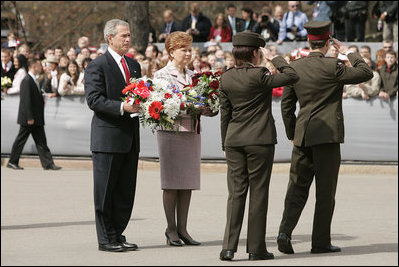 President George W. Bush and Latvia's President Vaira Vike-Freiberga participate in a wreath-laying ceremony in front of the Freedom Monument in Riga, May 7, 2005.