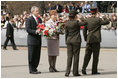 President George W. Bush and Latvia's President Vaira Vike-Freiberga participate in a wreath-laying ceremony in front of the Freedom Monument in Riga, May 7, 2005.