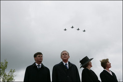 Jan Peter Balkenende, Prime Minister of The Netherlands, left, President George W. Bush, Queen Beatrix of The Netherlands, and Mrs. Laura Bush stand on stage Sunday, May 8, 2005, at the Netherlands American Cemetery in Margraten, as a flyover marks the remembrance of those who served in World War II.