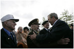 President George W. Bush greets veterans at the Netherlands American Cemetery in Margraten Sunday, May 8, 2005, following a ceremony honoring those who served in World War II.