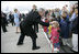 Greeted by a flowers and smiles, President George W. Bush returns the gesture during his and Laura Bush's arrival in Margratent, Netherlands, May 7, 2005.