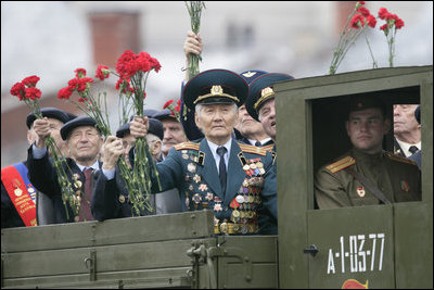 Veterans of Russia's military hold up flowers as they ride through Moscow's Red Square in a parade held to commemorate the 60th Anniversary of the end of World War II Monday, May 9, 2005.