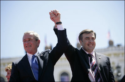 President George W. Bush and President Mikhail Saakashvili of Georgia react to the cheering of thousands of Tbilisi citizens in Freedom Square Tuesday, May 10, 2005.  "You are building a democratic society where the rights of minorities are respected, where a free press flourishes, a vigorous opposition is welcome, and unity is achieved through peace," said the President in his remarks. "In this new Georgia, the rule of law will prevail, and freedom will be the birthright of every citizen."  