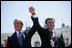 President George W. Bush and President Mikhail Saakashvili of Georgia react to the cheering of thousands of Tbilisi citizens in Freedom Square Tuesday, May 10, 2005.  "You are building a democratic society where the rights of minorities are respected, where a free press flourishes, a vigorous opposition is welcome, and unity is achieved through peace," said the President in his remarks. "In this new Georgia, the rule of law will prevail, and freedom will be the birthright of every citizen."  