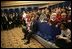 President George W. Bush and Laura Bush sit with children of embassy staff during their visit with U.S. Embassy employees Monday, Feb. 21, 2005, at the Sheraton Brussels Hotel and Towers in Brussels.