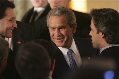 President George W. Bush greets fellow leaders and audience members during his address at Concert Noble Ballroom in Brussels, Belgium, Monday, Feb. 21, 2005. “In all these ways, our strong friendship is essential to peace and prosperity across the globe,” said the President in his speech.