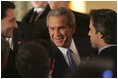 President George W. Bush greets fellow leaders and audience members during his address at Concert Noble Ballroom in Brussels, Belgium, Monday, Feb. 21, 2005. “In all these ways, our strong friendship is essential to peace and prosperity across the globe,” said the President in his speech.