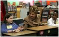 Mrs. Bush greets Hainerberg Elementary School student Hailey Cook during her visit with fourth and fifth graders Tuesday, Feb. 22, 2005 in Wiesbaden, Germany. 