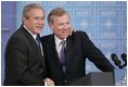 President George W. Bush is welcomed by NATO Secretary General Jaap de Hoop Scheffer during a news conference Tuesday, Feb. 22, 2005, at NATO Headquarters in Brussels.