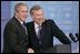 President George W. Bush is welcomed by NATO Secretary General Jaap de Hoop Scheffer during a news conference Tuesday, Feb. 22, 2005, at NATO Headquarters in Brussels.