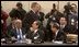 President George W. Bush walks past delegates and media as he enters a plenary session of the North Atlantic Council at NATO Headquarters in Brussels Tuesday, Feb. 22, 2005. 