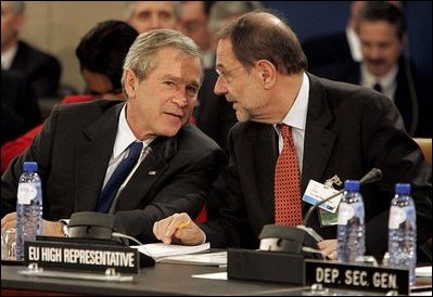 President George W. Bush speaks with European Union High Representative Javier Solana during a plenary session of the North Atlantic Council at NATO Headquarters in Brussels Tuesday, Feb. 22, 2005. 