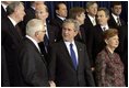 President George W. Bush speaks with Czech President Vaclav Klaus as world leaders take their place for the official NATO photo at the NATO Headquarters in Brussels Tuesday, Feb. 22, 2005. 