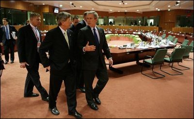 After meeting with European Union leaders, President George W. Bush walks with EU President Jean-Claude Juncker at Justus Lipsius in Brussels.