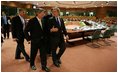 After meeting with European Union leaders, President George W. Bush walks with EU President Jean-Claude Juncker at Justus Lipsius in Brussels.