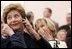 Laura Bush listens to translation headphones during a joint press conference with President George W. Bush and German Chancellor Gerhard Schroeder at the Electoral Palace in Mainz, Germany, Wednesday, Feb. 23, 2005. The Chancellor.s wife, Mrs. Schroeder-Koepf is seated next to Mrs. Bush.