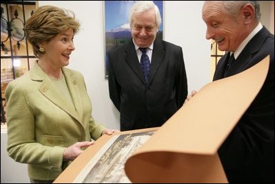 During the opening of University Library's "Info USA," Tibor Trgina, General Director of the library, shows Laura Bush books and artwork preserved at the library in Bratislava, Slovak Republic. Laura Bush was also joined by Slovak Republic's Minister of Culture Rudolf Chmel, center, during her visit to the library, Thursday, Feb. 24, 2005.