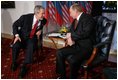 President George W. Bush leans in to speak with Russia President Vladimir Putin Thursday, Feb. 24, 2005 during a photo opportunity in Bratislava, Slovakia. The meeting of the two leaders marked the last during President Bush's five-day European trip.