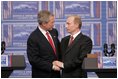 President George W. Bush and Russia President Vladimir Putin clasp hands after a joint news conference Thursday, Feb. 24, 2005, in Bratislava, Slovakia. Said President Bush, "I applaud President Putin for dealing with a country that is in transformation," adding, "It's been hard work."