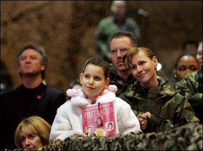 Audience members listen to a speech by Laura Bush praising the sacrifice and hard work of the U.S. military and their families Tuesday, Feb. 22, 2005 at Ramstein Air Base in Ramstein, Germany. 