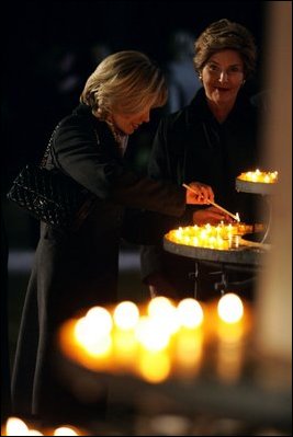 Laura Bush and Mrs. Schroeder-Koepf light candles during a tour of Saint Martin's Cathedral in Mainz, Germany, Feb. 23, 2005. 