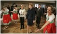 Laura Bush watches dancers during a Wednesday, Feb. 23, 2005, lunch hosted by Chancellor Gerhard Schroeder, behind, and Mrs. Schroeder-Koepf, left, at the Electoral Palace in Mainz, Germany. 