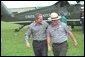 President George W. Bush talks with national park service officers at the Royal Palm Visitors Center at Everglades National Park, Fla., June 4, 2001. White House photo by Eric Draper.