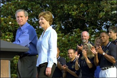 President George W. Bush and Mrs. Bush announce the Healthier US initiative on the South Lawn of the White House June 20. As part of the initiative, President Bush signed two executive orders and named Football Hall of Famer Lynn Swann as Chair and Olympic Gold Medalist in Softball Dot Richardson as Vice Chair to the President's Council on Physical Fitness.