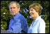 President George W. Bush and Mrs. Bush announce the Healthier US initiative on the South Lawn of the White House June 20. As part of the initiative, President Bush signed two executive orders and named Football Hall of Famer Lynn Swann as Chair and Olympic Gold Medalist in Softball Dot Richardson as Vice Chair to the President's Council on Physical Fitness.