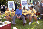 Touring the exhibits, President Bush takes a few moments to visit with children at the hiking /outdoor activity exhibit.