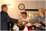 Accompanied by the Governor of Florida, his brother Jeb Bush, President George W. Bush visits senior citizens participating in an aerobic "spinning class" at the Marks Street Senior Recreation Complex in Orlando, Fla., Friday, June 21, 2002. White House Photo by Tina Hager.