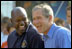 President George W. Bush takes in the excitement of the White House Fitness Expo on the South Lawn with Dallas Cowboys Running Back Emmitt Smith June 20. 