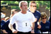 President George W. Bush starts the 3 mile run while Mrs. Bush, number 2, starts the 1.5 mile walk at Ft. McNair as part of The President's Fitness Challenge on Saturday June 21, 2002.