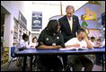 President George W. Bush talks with students at the South End Community Center in Bridgeport, Conn., Tuesday, April, 9, 2002. Americorps volunteers come to the community center to mentor students. "We need to encourage programs to expand, to give people an outlet, a chance to participate," said the President during his remarks at the city's Klein Auditorium where he oulined how people could join the ranks of thousands who are already serving in one America's Freedom Corps groups.