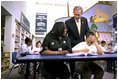 President George W. Bush talks with students at the South End Community Center in Bridgeport, Conn., Tuesday, April, 9, 2002. Americorps volunteers come to the community center to mentor students. "We need to encourage programs to expand, to give people an outlet, a chance to participate," said the President during his remarks at the city's Klein Auditorium where he oulined how people could join the ranks of thousands who are already serving in one America's Freedom Corps groups.