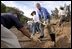 Working alongside volunteers, President George W. Bush lends a hand in repairing the Old Boney Trail at the Santa Monica Mountains National Recreation Area in Thousand Oaks, Calif., Aug. 15, 2003.