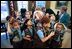 President Bush meets with a Girl Scout Brownies in the Oval Office March 1, 2004. The day after their visit a new program was announced that will soon allow Iraqi children to participate in an Iraqi Boy Scout and Girl Scout program. The history of scouting in Iraq dates back to 1921, but all programs were terminated in the Saddam Hussein era. "The reestablishment of scouting signals a brighter future for Iraq's youth and is another step forward in reconnecting Iraq with the world community," stated the White House in a press release.