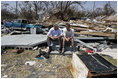 President George W. Bush spends a moment with a Patrick Wright during his walking tour Friday, Sept. 2, 2005, of Biloxi, Miss. "You know, there's a lot of sadness, of course," said the President of the devastated area. "But there's also a spirit here in Mississippi that is uplifting."