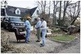 Vice President Dick Cheney and Mayor Greg Warr talk with one resident of a Gulfport, Mississippi neighborhood who's house was damaged recently by Hurricane Katrina Thursday, September 8, 2005.  Vice President and Mrs. Cheney took a walking tour of neighborhood and met with local residents of the area.